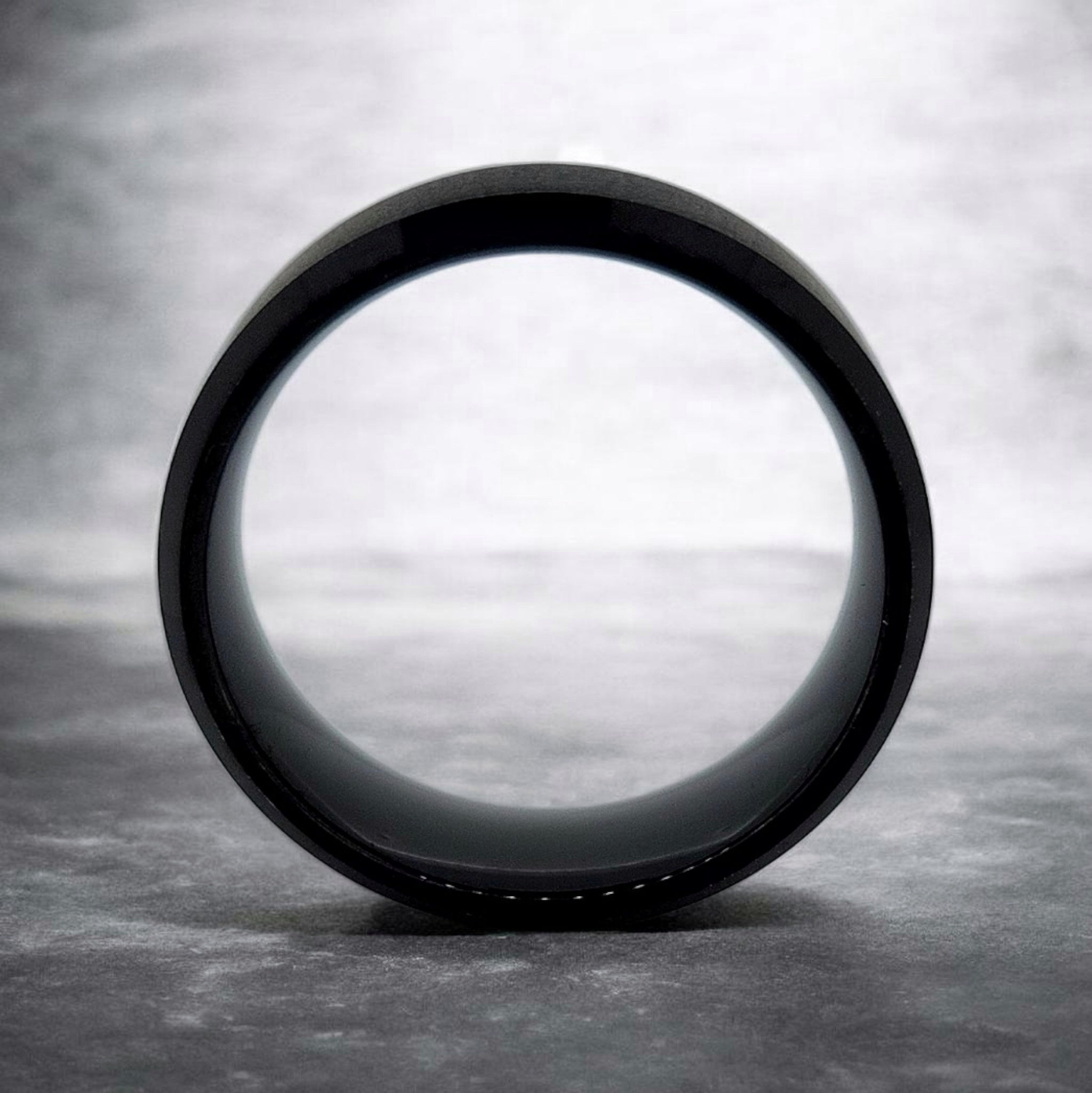 Front view of black tungsten ring showing band thickness and beveled shape