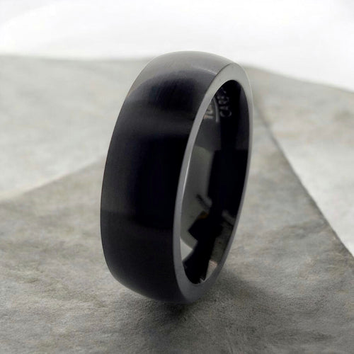 Angled view of black domed tungsten ring highlighting smooth profile and matte finish