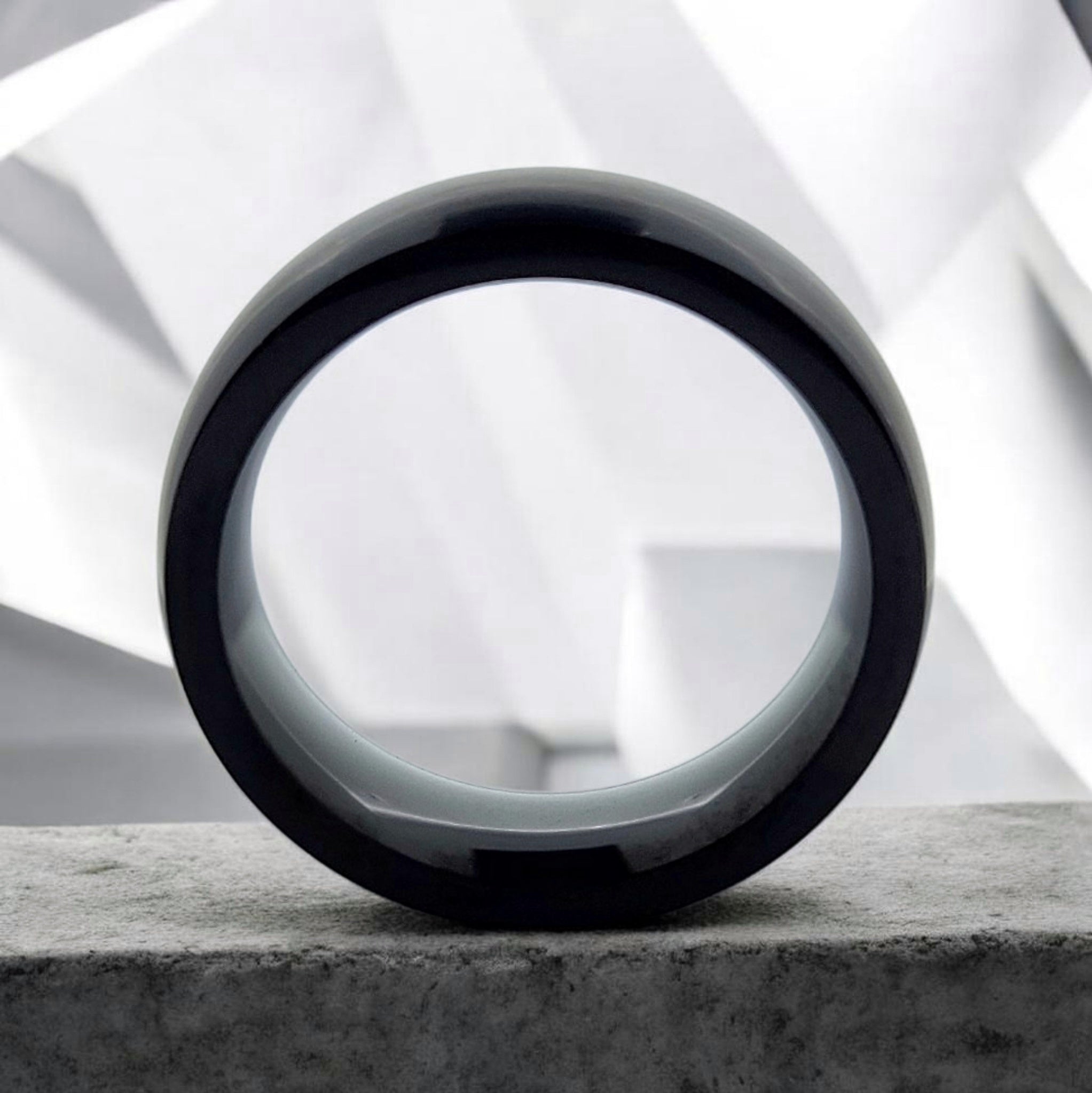 Front view of black domed tungsten ring showing band thickness and inner profile