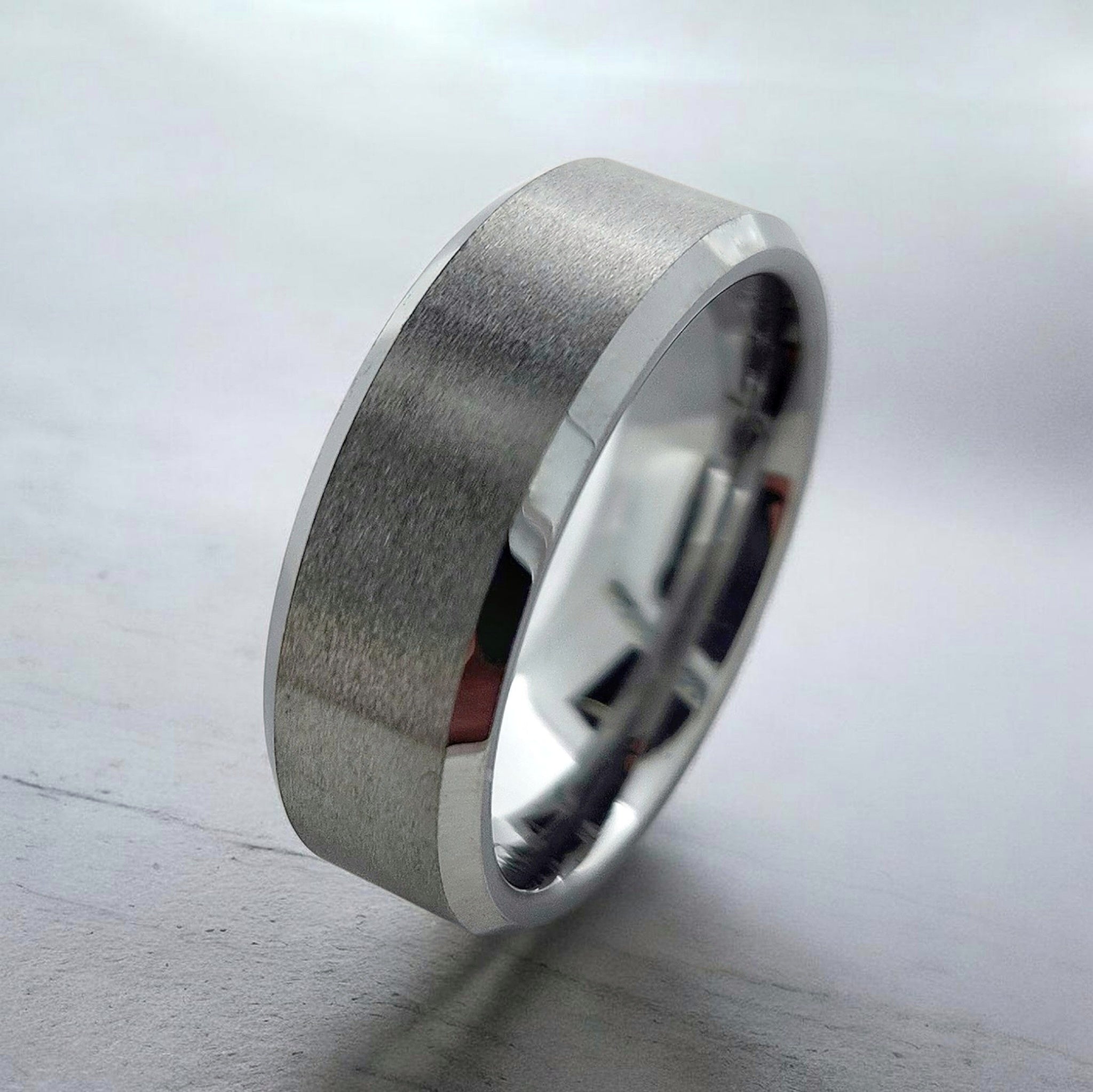 Angled view of silver tungsten ring highlighting beveled edges and matte finish