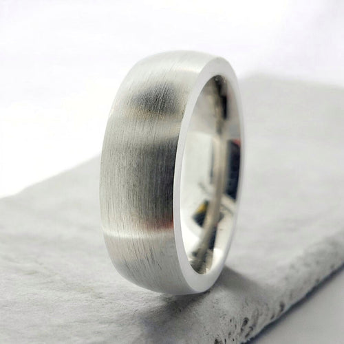 Angled view of silver domed tungsten ring highlighting smooth profile and matte finish